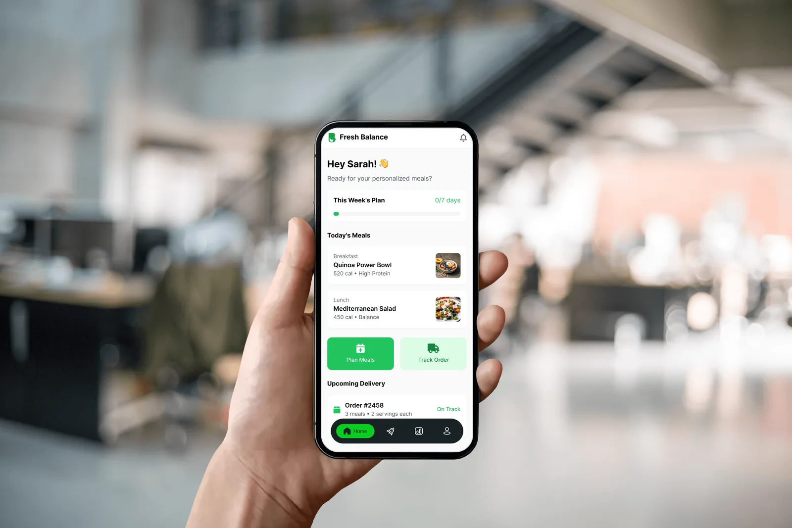 The app held in one hand in an office