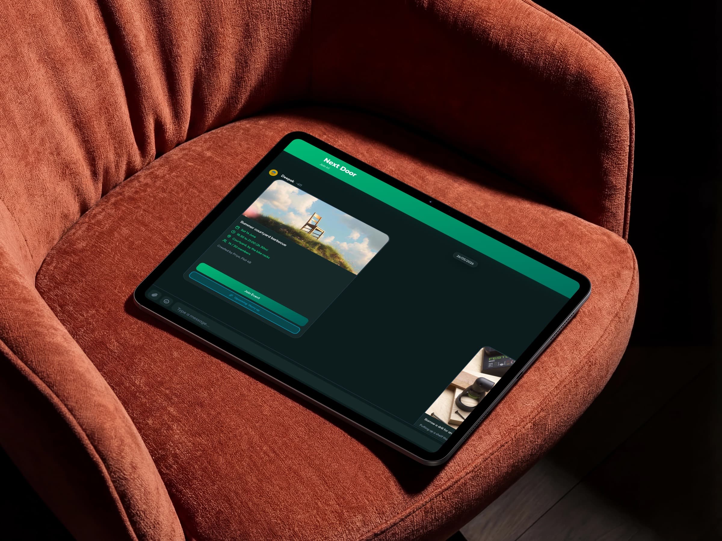 A tablet on a rust-coloured armchair in a dark room, running Next Door in dark mode with an event card open